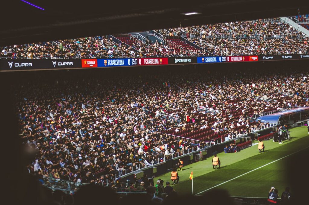Packed stadium with spectators at an FC Barcelona soccer match, vibrant atmosphere.
